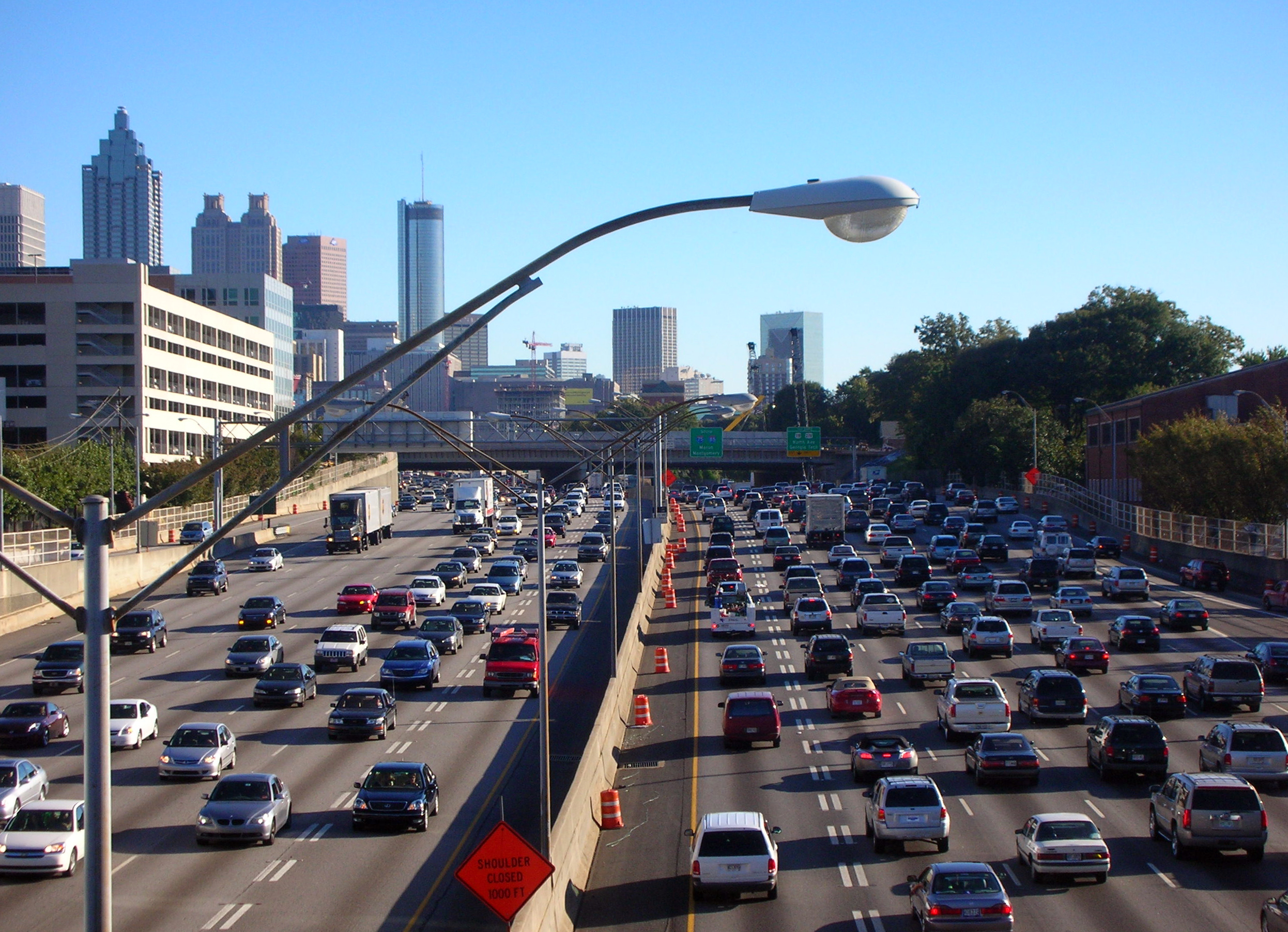 The downtown Atlanta skyline seen from a highway on a clear afternoon.