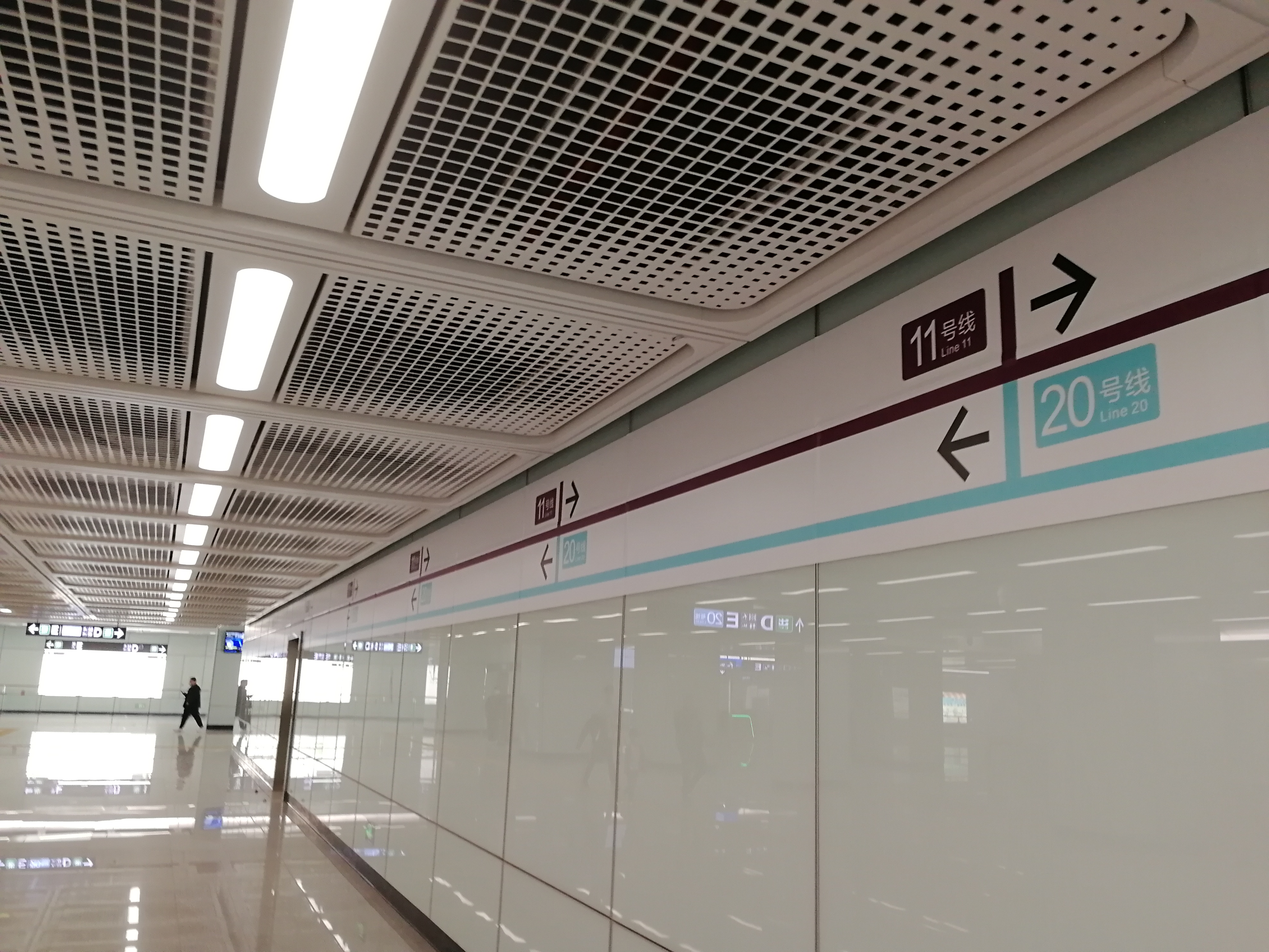 An overhead sign in an airport terminal directing connecting passengers toward flight transfers, away from the arrivals exit.